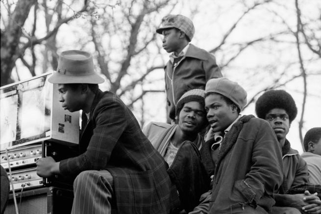 Youths listening to sound system at Victoria Park, London E3, 1980. Copyright David Corio.