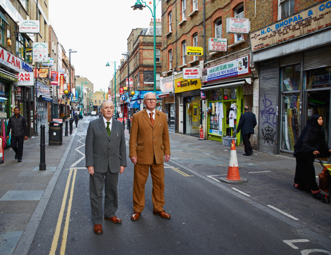 Gilbert & George by Robin Friend. Copyright TransGlobe Publishing. Images courtesy of London Burning: Portraits from a Creative City. Gilbert & George strike their trademark pose on Brick Lane, once a site for the digging of brick-earth, now famous for its Bengali curry houses.